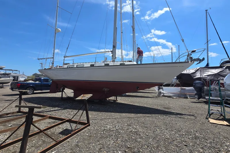 Slide: The Image of 1983 Bristol 38.8 sailboat on dry dock under clear blue sky. - 29