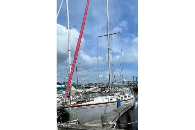 Slide: The Image of 1983 Bristol 38.8 sailboat docked at marina under blue sky. - 3