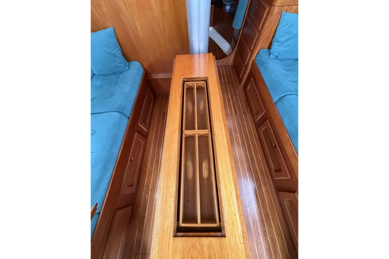 Slide: The Image of Interior of 1983 Bristol 38.8 yacht with wooden flooring and blue cushioned seating. - 33