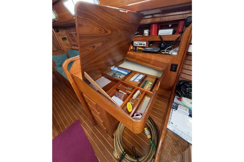 Slide: The Image of Interior of 1983 Bristol 38.8 sailboat with open wooden storage compartment. - 36