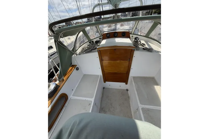 Slide: The Image of Cockpit of 1983 Bristol 38.8 sailboat with wooden accents and navigation instruments. - 38