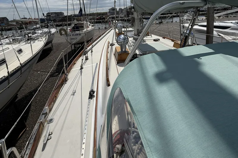 Slide: The Image of 1983 Bristol 38.8 sailboat docked in a marina, showcasing deck and rigging details. - 39