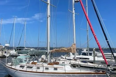 Slide: The Image of 1983 Bristol 38.8 sailboat docked at marina under clear blue sky. - 4