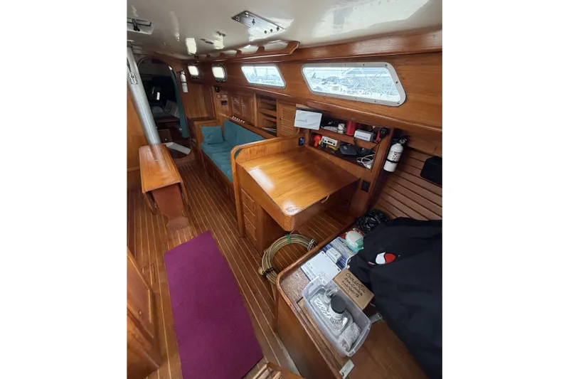 Slide: The Image of Interior of a 1983 Bristol 38.8 sailboat with wooden furnishings and seating area. - 43