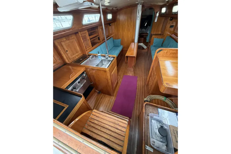 Slide: The Image of Interior of 1983 Bristol 38.8 sailboat with wooden cabinetry and cozy seating. - 44