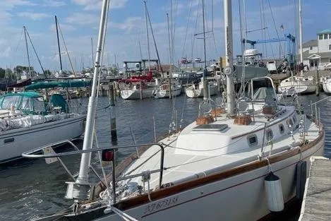 Slide: The Image of 1983 Bristol 38.8 sailboat docked in a marina with other boats. - 5