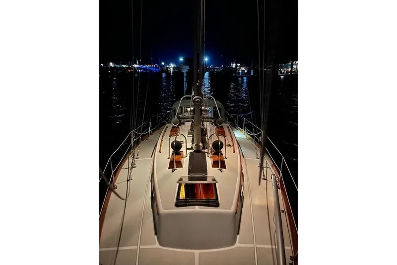 Slide: The Image of 1983 Bristol 38.8 sailboat deck at night, illuminated by harbor lights. - 9
