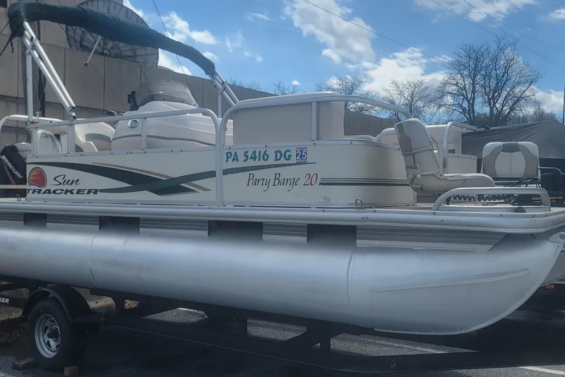 The Image of 2011 Sun Tracker Party Barge 20 Classic pontoon boat on trailer under blue sky. - 0
