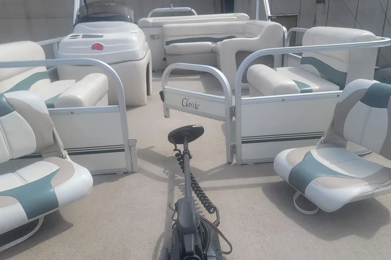 Slide: The Image of 2011 Sun Tracker Party Barge 20 Classic Series interior with seating and helm. - 12