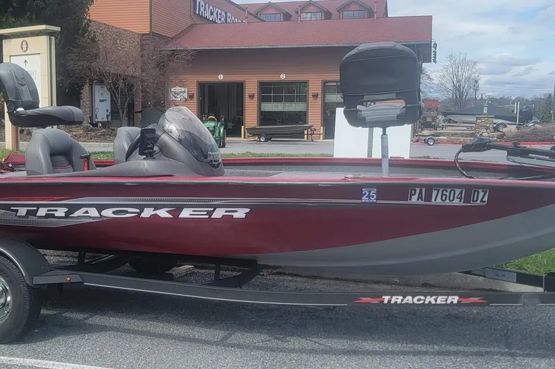The Image of 2021 Tracker Pro Team 175 TXW boat on trailer, parked outside a building. - 0