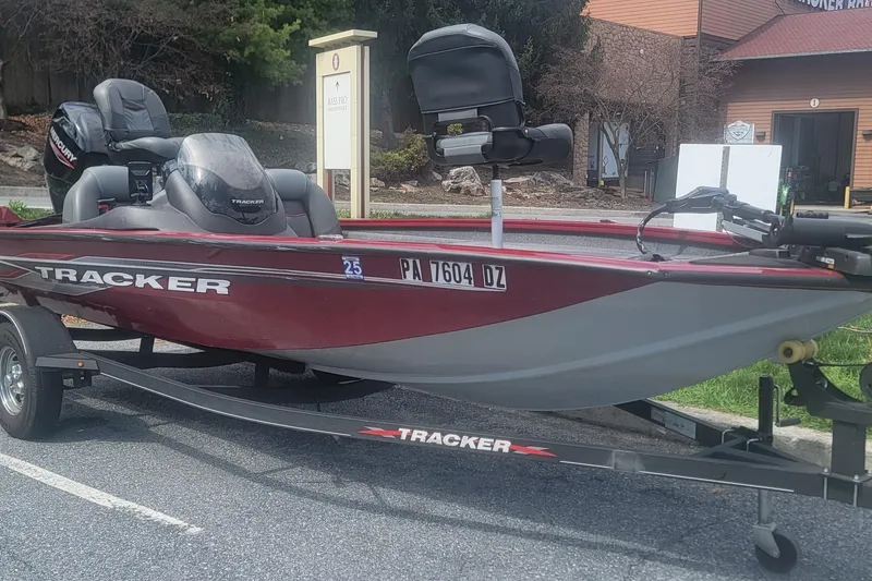 Slide: The Image of 2021 Tracker Pro Team 175 TXW boat on trailer, parked outdoors. - 2