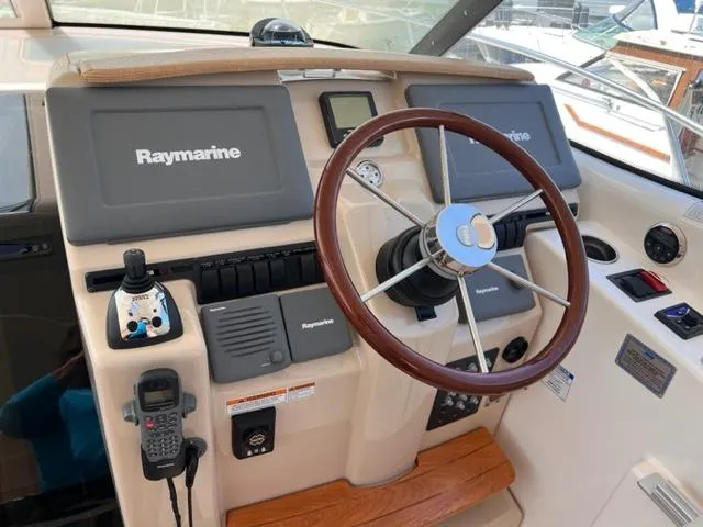 Slide: The Image of 2008 Tiara Yachts 3900 Sovran helm with Raymarine electronics and wooden steering wheel. - 12