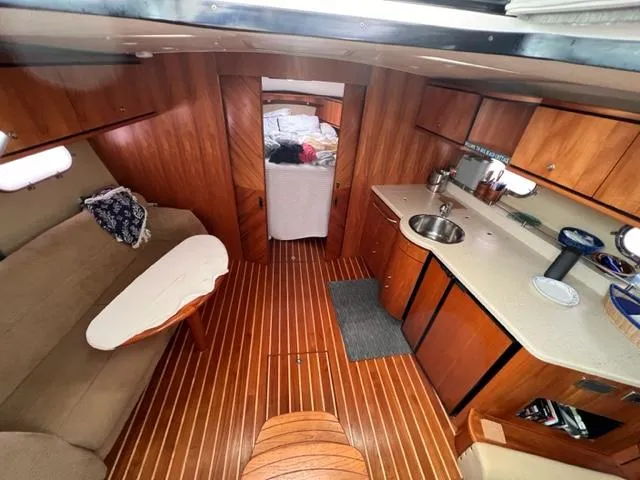 Slide: The Image of 2008 Tiara Yachts 3900 Sovran interior with wood flooring, kitchenette, and seating area. - 20