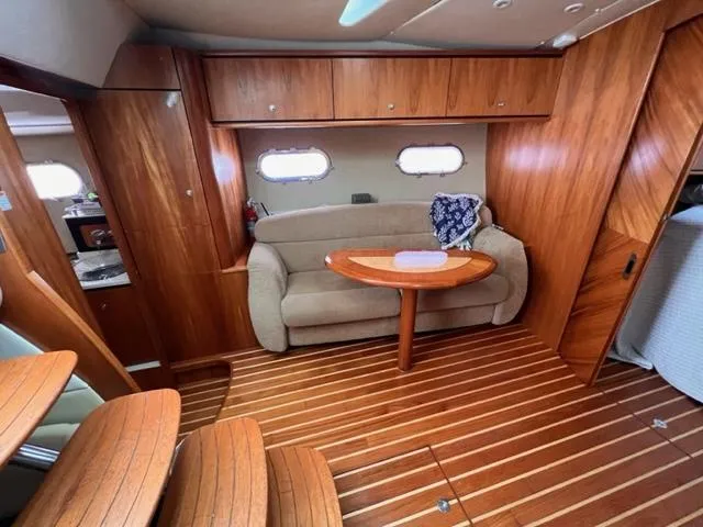 Slide: The Image of 2008 Tiara Yachts 3900 Sovran interior with wooden finishes and cozy seating area. - 21