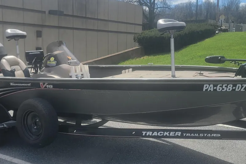 The Image of 2008 Tracker Tournament V-18 fishing boat on trailer, parked outdoors. - 0
