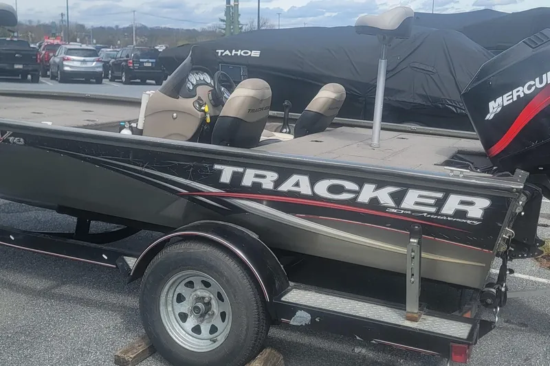 Slide: The Image of 2008 Tracker Tournament V-18 boat on trailer, featuring Mercury outboard motor. - 2