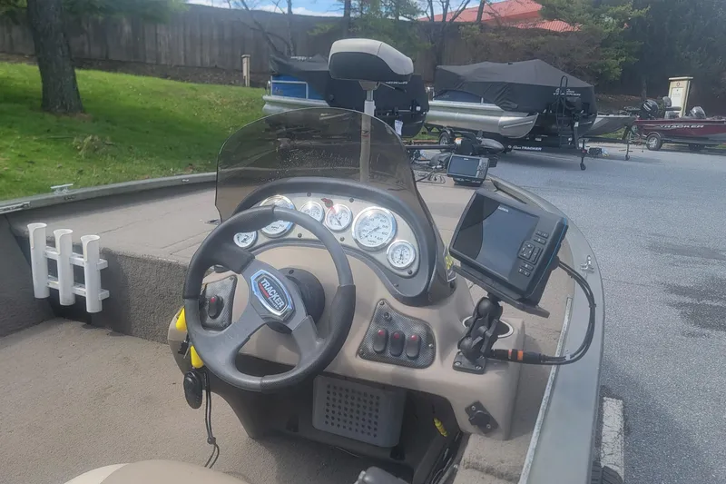 Slide: The Image of 2008 Tracker Tournament V-18 boat dashboard with steering wheel and navigation equipment. - 4