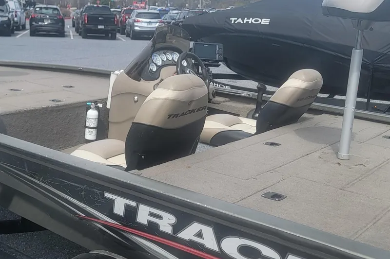 Slide: The Image of 2008 Tracker Tournament V-18 boat interior with seats and dashboard in a parking lot. - 8
