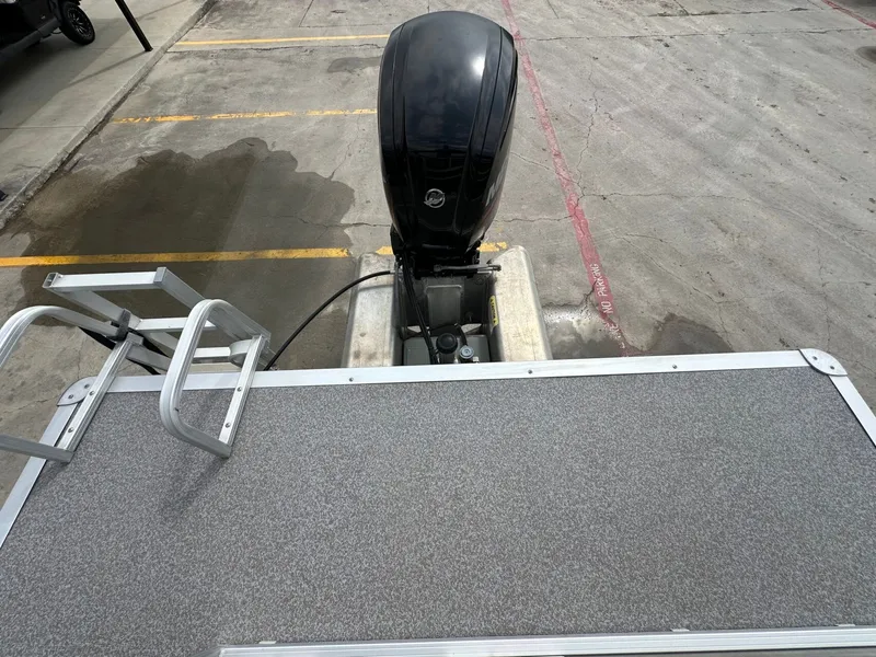 Slide: The Image of 2017 Tracker 20 DLX boat with outboard motor and ladder. - 10