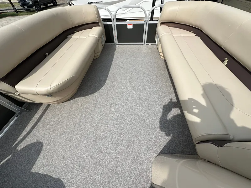 Slide: The Image of Interior of a 2017 Tracker 20 DLX pontoon boat with beige seating. - 18