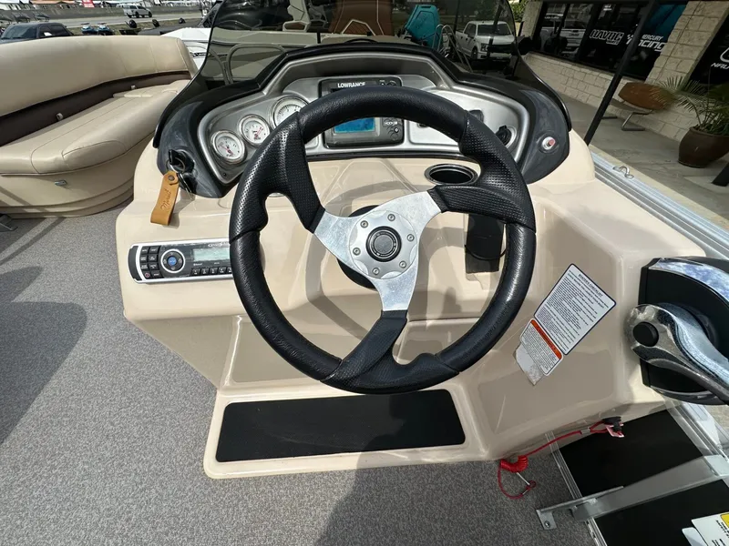 Slide: The Image of Steering wheel and dashboard of a 2017 Tracker 20 DLX boat. - 23