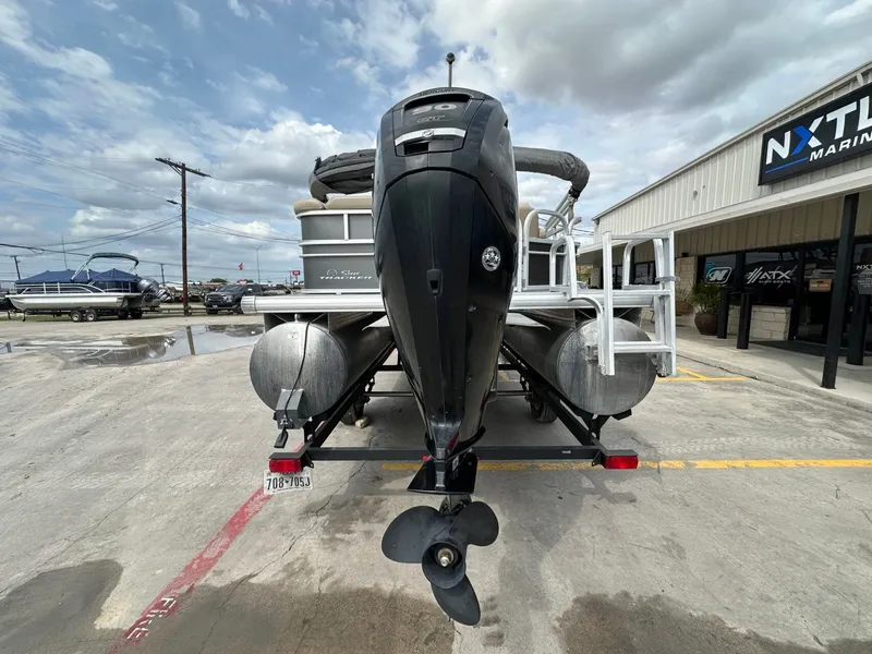 Slide: The Image of 2017 Tracker 20 DLX pontoon boat with outboard motor on parking lot. - 4