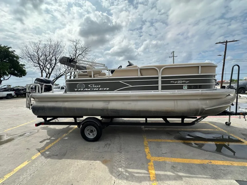 Slide: The Image of 2017 Tracker 20 DLX pontoon boat parked on trailer outdoors. - 6