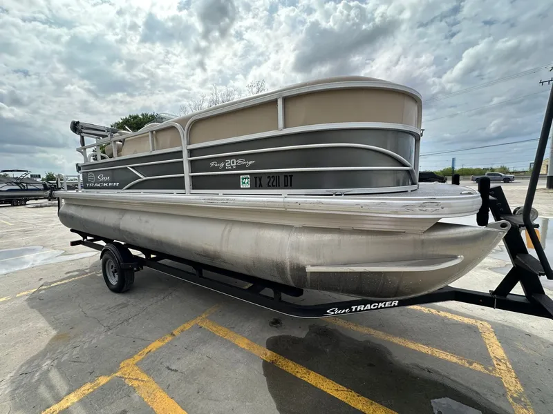 Slide: The Image of 2017 Tracker 20 DLX pontoon boat on trailer, cloudy sky. - 7