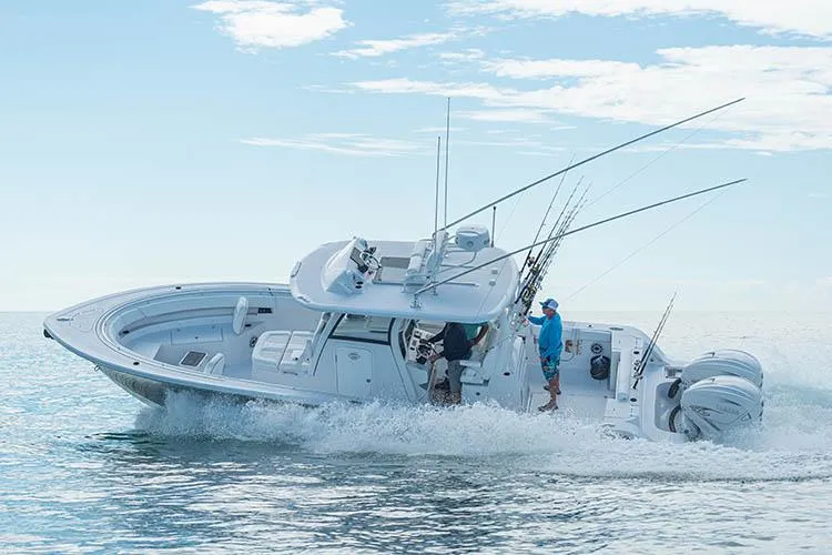 Slide: The Image of Manufacturer Provided Image: 2025 Sportsman Open 322 Center Console boat cruising on the ocean. - 1