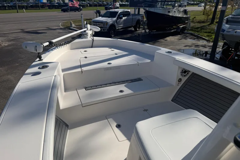 Slide: The Image of 2022 Pathfinder 2700 Open boat interior with seating and storage compartments. - 2