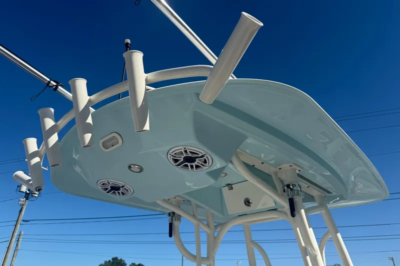 Slide: The Image of 2022 Pathfinder 2700 Open boat top view with rod holders and speakers against blue sky. - 5