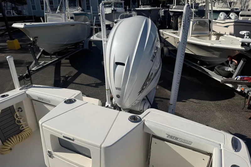 Slide: The Image of 2022 Pathfinder 2700 Open boat with Yamaha outboard motor, docked among other boats. - 8