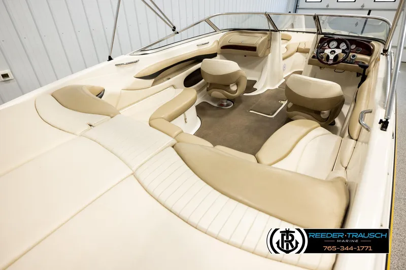 Slide: The Image of 2006 Glastron GX 235 boat interior with beige seating and dashboard. - 12