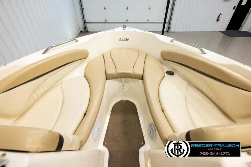 Slide: The Image of 2006 Glastron GX 235 boat interior with beige seating and cup holders. - 15