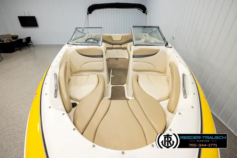 Slide: The Image of 2006 Glastron GX 235 boat interior with beige seating and yellow exterior. - 16