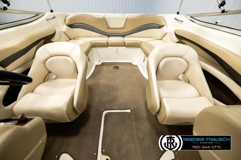 Slide: The Image of 2006 Glastron GX 235 boat interior with beige seating and carpeted floor. - 17