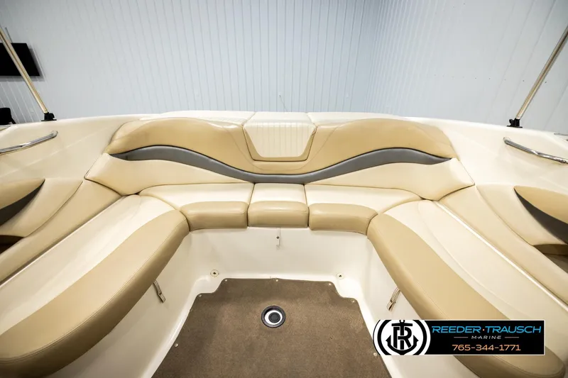 Slide: The Image of 2006 Glastron GX 235 boat interior with beige seating and modern design. - 18