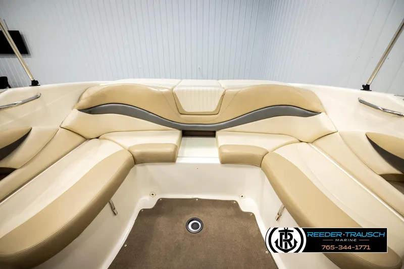 Slide: The Image of 2006 Glastron GX 235 boat interior with beige seating and gray accents. - 19
