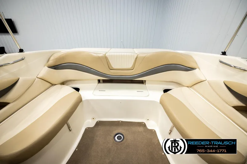 Slide: The Image of 2006 Glastron GX 235 boat interior with beige seating and carpeted floor. - 20