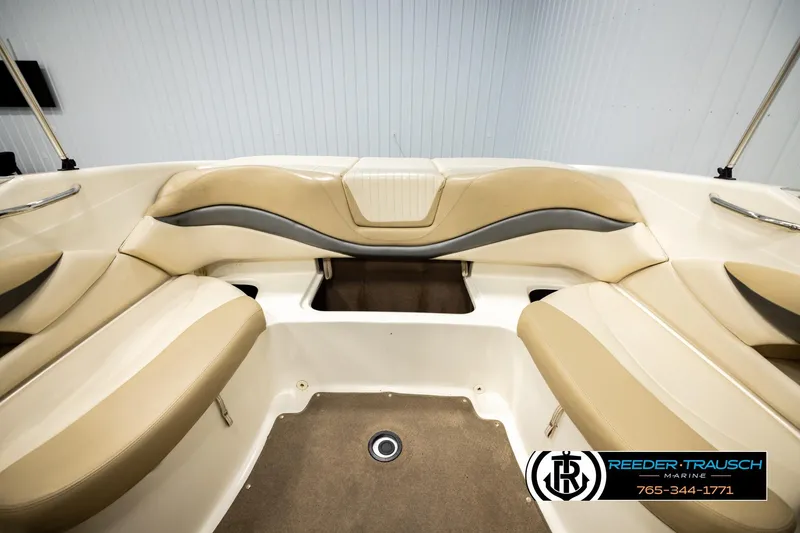 Slide: The Image of 2006 Glastron GX 235 boat interior with beige seating and carpeted floor. - 21