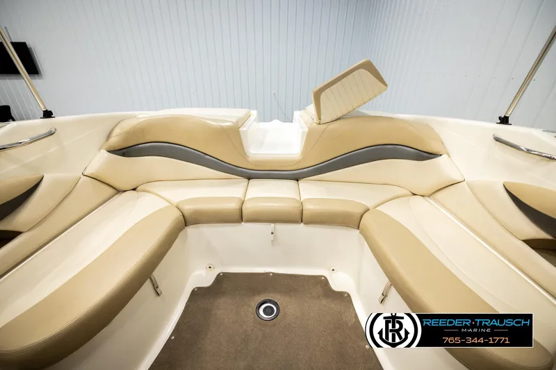 Slide: The Image of 2006 Glastron GX 235 boat interior with beige seating and sleek design. - 22