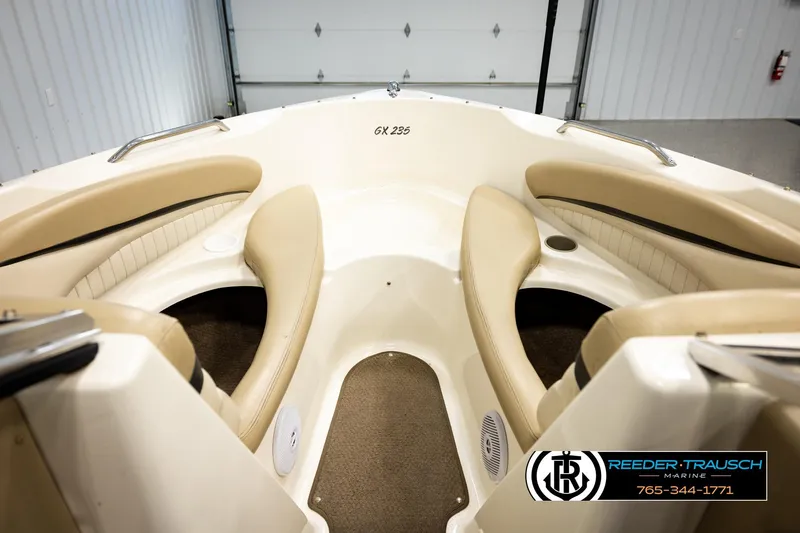 Slide: The Image of Interior view of a 2006 Glastron GX 235 boat with beige seating. - 25