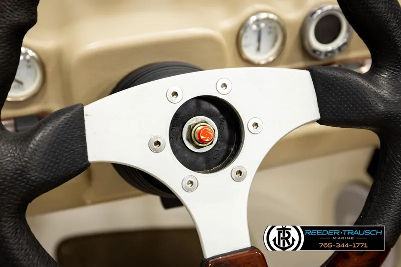 Slide: The Image of Steering wheel of 2006 Glastron GX 235 boat, featuring dashboard gauges. - 30