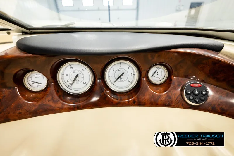 Slide: The Image of Dashboard of a 2006 Glastron GX 235 boat with gauges and controls. - 32