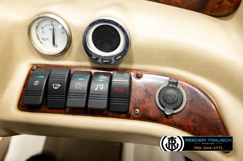 Slide: The Image of 2006 Glastron GX 235 dashboard with switches, gauge, and 12V outlet. - 33