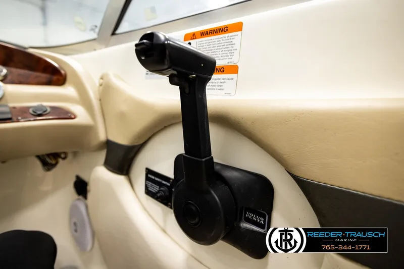 Slide: The Image of 2006 Glastron GX 235 boat interior with throttle control and warning labels. - 34