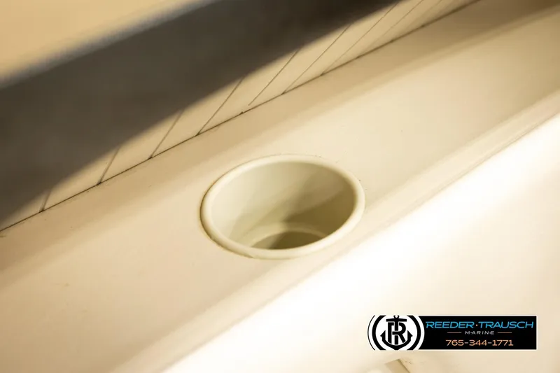 Slide: The Image of Cup holder on 2006 Glastron GX 235 boat interior, Reeder-Trausch Marine logo visible. - 39