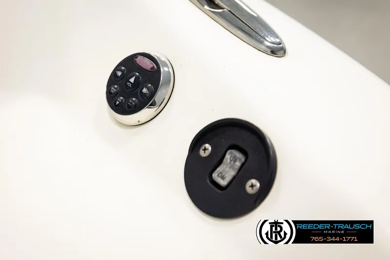 Slide: The Image of Control panel on a 2006 Glastron GX 235 boat, featuring buttons and a switch. - 41