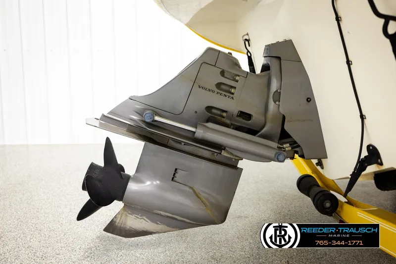 Slide: The Image of 2006 Glastron GX 235 boat with Volvo Penta outdrive, showcased in a showroom setting. - 44