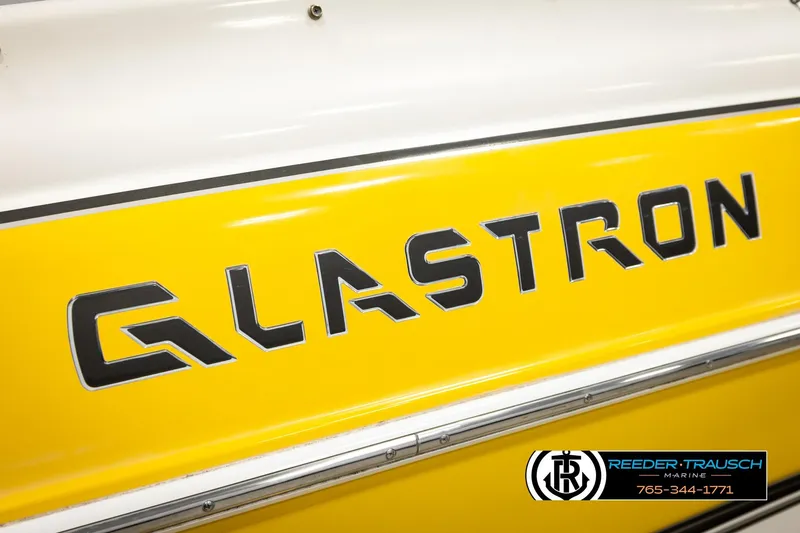 Slide: The Image of Yellow 2006 Glastron GX 235 boat with bold logo and Reeder-Trausch Marine branding. - 48